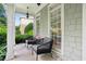 Cozy front porch with comfortable seating, offering a relaxing outdoor space with charming curb appeal at 4944 Dovecote Trl, Suwanee, GA 30024