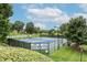 View of tennis courts surrounded by lush trees and landscaping, offering a recreational amenity at 4944 Dovecote Trl, Suwanee, GA 30024