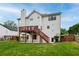 Back exterior of the house featuring a wooden deck and a green lawn at 980 Charter Club Dr, Lawrenceville, GA 30043