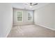 Neutral bedroom offering carpeted floors and two sunny windows at 980 Charter Club Dr, Lawrenceville, GA 30043