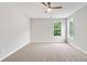 Spacious bedroom with carpeted floors, two windows, and a ceiling fan at 980 Charter Club Dr, Lawrenceville, GA 30043