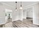 Bright dining room featuring hardwood floors and modern lighting, offering an inviting space for meals and gatherings at 980 Charter Club Dr, Lawrenceville, GA 30043