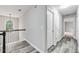 Hallway with hardwood floors, neutral paint, and view of arched window at 980 Charter Club Dr, Lawrenceville, GA 30043