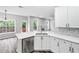 Bright kitchen with white cabinetry, stainless steel dishwasher, and a functional island for food preparation and serving at 980 Charter Club Dr, Lawrenceville, GA 30043