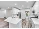 Bright kitchen features white cabinets, stainless steel appliances, quartz countertops and modern finishes at 980 Charter Club Dr, Lawrenceville, GA 30043