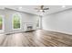 Inviting living room with a cozy fireplace, hardwood floors, and abundant natural light from large windows at 980 Charter Club Dr, Lawrenceville, GA 30043