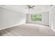 Spacious main bedroom features a tray ceiling, ceiling fan, and a large window at 980 Charter Club Dr, Lawrenceville, GA 30043
