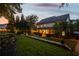 Night view of a home's landscaped backyard featuring ambient string lights and a stone retaining wall at 1059 Rockford Township Sw Dr, Marietta, GA 30064