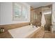 Primary bathroom featuring tile floors, a drop-in tub with tile surround, and a tiled shower with glass door at 1059 Rockford Township Sw Dr, Marietta, GA 30064