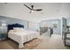Charming bedroom with blue walls, a ceiling fan, plush carpet, and a staircase at 1059 Rockford Township Sw Dr, Marietta, GA 30064