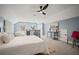 Bright bedroom featuring a ceiling fan, white bedding, light blue walls, and plush carpet at 1059 Rockford Township Sw Dr, Marietta, GA 30064