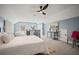 Cozy bedroom features blue walls, a ceiling fan, plush carpet, and natural light at 1059 Rockford Township Sw Dr, Marietta, GA 30064