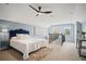 Bright bedroom featuring a ceiling fan, white bedding, light blue walls, and a faux fur rug at 1059 Rockford Township Sw Dr, Marietta, GA 30064