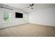 Spacious bedroom featuring neutral carpet, plantation blinds, ceiling fan, and bright white walls at 1059 Rockford Township Sw Dr, Marietta, GA 30064