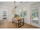 Dining area features a modern light fixture and a view of the backyard and adjacent bedroom at 1059 Rockford Township Sw Dr, Marietta, GA 30064