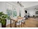 Dining area features an modern light fixture and a view of the backyard and fireplace at 1059 Rockford Township Sw Dr, Marietta, GA 30064