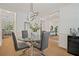 Modern dining room featuring a glass table, stylish chairs, contemporary light fixture, and hardwood floors at 1059 Rockford Township Sw Dr, Marietta, GA 30064