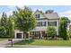 Beautiful two-story home with a well-manicured lawn, black shutters, and a vibrant red front door at 1059 Rockford Township Sw Dr, Marietta, GA 30064