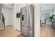 Stainless steel refrigerator stands next to a dining room and hardwood floors at 1059 Rockford Township Sw Dr, Marietta, GA 30064