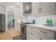 Bright kitchen features modern stainless steel range, hood, and ample storage, accented by hardwood flooring at 1059 Rockford Township Sw Dr, Marietta, GA 30064