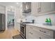 A close up view of the kitchen with stainless steel oven and range with white cabinets and backsplash at 1059 Rockford Township Sw Dr, Marietta, GA 30064