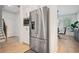 Kitchen features stainless steel fridge and eat-in area with views to formal dining room and foyer at 1059 Rockford Township Sw Dr, Marietta, GA 30064
