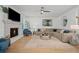 Spacious living room with a stone fireplace, hardwood floors, a ceiling fan, and comfortable seating at 1059 Rockford Township Sw Dr, Marietta, GA 30064
