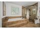 This bathroom features a jetted tub, a tiled shower, and a large window at 1059 Rockford Township Sw Dr, Marietta, GA 30064