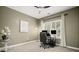 Office features an adjustable desk, neutral walls, a ceiling fan, and a window at 1059 Rockford Township Sw Dr, Marietta, GA 30064