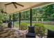 Back patio with stone flooring, ceiling fans, grill, and view into the backyard at 1059 Rockford Township Sw Dr, Marietta, GA 30064