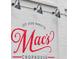 Exterior of 'Mac's Chophouse' with a white brick wall and black sconce lighting at 1059 Rockford Township Sw Dr, Marietta, GA 30064
