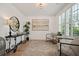 Sitting room with neutral tones, area rug, plantation shutters, and wrought iron table at 1059 Rockford Township Sw Dr, Marietta, GA 30064