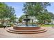 Town square featuring a fountain, mature trees, and people enjoying the public space at 1059 Rockford Township Sw Dr, Marietta, GA 30064