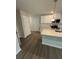 Well-lit kitchen boasts granite countertops, stainless steel appliances, and white cabinetry at 107 Deer Xing, Temple, GA 30179