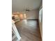 Spacious living room with gray wood flooring, ceiling fan, bright natural light, and vaulted ceilings at 107 Deer Xing, Temple, GA 30179