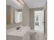 Bathroom with white vanity and mirror with an open doorway to another room at 4102 Barr Cir, Tucker, GA 30084