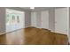 Bedroom with hardwood floors, white trim, two closets and open doorway at 4102 Barr Cir, Tucker, GA 30084