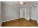 Bedroom features hardwood floors, ceiling fan and a closet with shelving at 4102 Barr Cir, Tucker, GA 30084