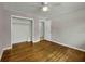 Bedroom features hardwood floors, a ceiling fan, and a closet with a view into another room at 4102 Barr Cir, Tucker, GA 30084