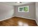 Bedroom with hardwood floors, ceiling fan, and a large window bringing in natural light at 4102 Barr Cir, Tucker, GA 30084