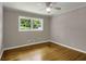 Bedroom with wood floors, white trim, ceiling fan and a window at 4102 Barr Cir, Tucker, GA 30084