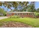 Charming brick home featuring a well-manicured lawn and mature trees, creating a welcoming curb appeal at 4102 Barr Cir, Tucker, GA 30084