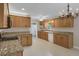 Well-lit kitchen featuring granite countertops, wood cabinets, updated appliances, and tile flooring at 4102 Barr Cir, Tucker, GA 30084