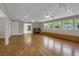 Bright living room with hardwood floors, neutral walls, track lights, windows, and doorway access at 4102 Barr Cir, Tucker, GA 30084