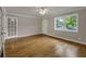 Bright living room with hardwood floors, large window, and a ceiling fan at 4102 Barr Cir, Tucker, GA 30084