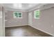 Finished room with drop ceiling, two windows and vinyl flooring at 4102 Barr Cir, Tucker, GA 30084