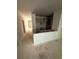 An unfinished kitchen area showing the cabinet placements adjacent to a well-lit, open-concept living space at 543 Courthouse Park Dr, Temple, GA 30179