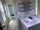 Stylish bathroom featuring a modern vanity, updated fixtures, and convenient shelving at 841 N North Price Rd, Sugar Hill, GA 30518