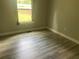 Cozy bedroom with durable wood-look flooring, a window with natural light, and neutral paint at 841 N North Price Rd, Sugar Hill, GA 30518