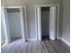 Spacious bedroom featuring two closets and modern gray floors at 841 N North Price Rd, Sugar Hill, GA 30518